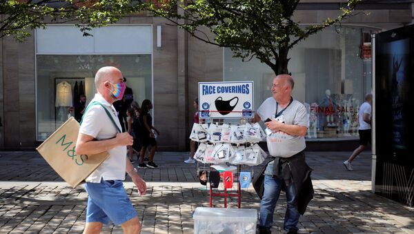 A man sells protective masks, as the city and surrounding area face local restrictions in an effort to avoid a local lockdown being forced upon the area, amid the coronavirus (COVID-19) outbreak, in Manchester - Sputnik International