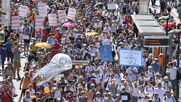 People attend a demonstration initiated by the initiative Querdenken-711 with the slogan the end of the pandemic-the day of freedom to protest against the current measurements to curb the COVID-19 spreading in Berlin, on August 1, 2020. - Sputnik International