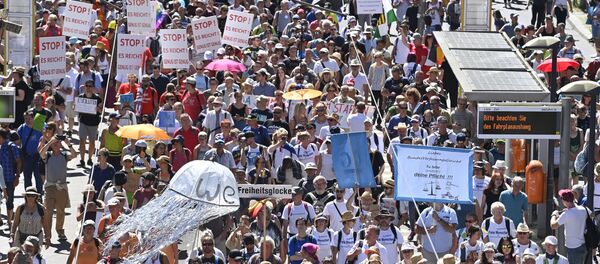 People attend a demonstration initiated by the initiative Querdenken-711 with the slogan the end of the pandemic-the day of freedom to protest against the current measurements to curb the COVID-19 spreading in Berlin, on August 1, 2020. - Sputnik International