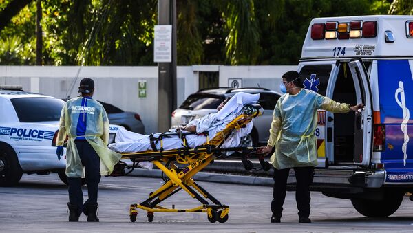 Medics transfer a patient on a stretcher from an ambulance outside of Emergency at Coral Gables Hospital where Coronavirus patients are treated in Coral Gables near Miami, on July 30, 2020. - Sputnik International