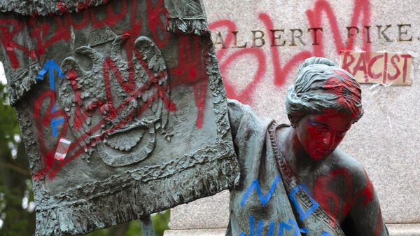 The bronze sculpture representing the Goddess of Masonry on the base of the statue of a Confederate general, Albert Pike, is seen with red paint, after protestors toppled Pike statue's and set on fire early Saturday, June 20, 2020, in Washington. It comes on Juneteenth, the day marking the end of slavery in the United States, amid continuing anti-racism demonstrations following the death of George Floyd in Minneapolis - Sputnik International