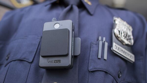 A police officer wears a newly issued body camera outside the 34th precinct, Thursday, April 27, 2017, in New York. The New York Police Department is launching the first phase of a plan to equip 22,000 officers with body cameras - Sputnik International