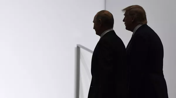 President Donald Trump and Russian President Vladimir Putin walk to participate in a group photo at the G20 summit in Osaka, Japan, Friday, June 28, 2019. File photo. - Sputnik International