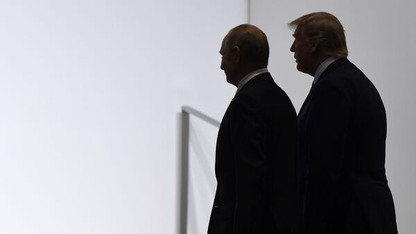 President Donald Trump and Russian President Vladimir Putin walk to participate in a group photo at the G20 summit in Osaka, Japan, Friday, June 28, 2019. File photo. - Sputnik International