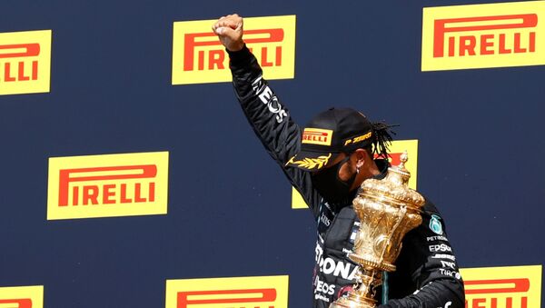 Mercedes' Lewis Hamilton celebrates winning the race on the podium with the trophy - Sputnik International