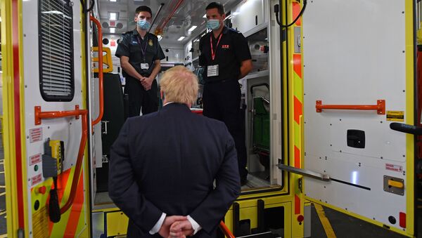 Britain's Prime Minister Boris Johnson talks with a paramedic Jack Binder and firefighter Tom Binder as he visits headquarters of the London Ambulance Service NHS Trust, amid the spread of the coronavirus disease (COVID-19), in London, Britain July 13, 2020.  - Sputnik International