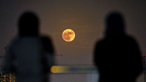 Two Iranian women watch the moon rising over Tehran in Iran (File) - Sputnik International