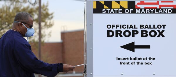 A resident drops off a mail-in ballot at the Edmondson Westside High School Polling site in Baltimore, Maryland, U.S., April 28, 2020 A resident drops off a mail-in ballot at the Edmondson Westside High School Polling site in Baltimore, Maryland, U.S., April 28, 2020 - Sputnik International
