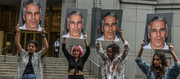 A protest group called Hot Mess hold up signs of Jeffrey Epstein in front of the Federal courthouse on July 8, 2019 in New York City - Sputnik International
