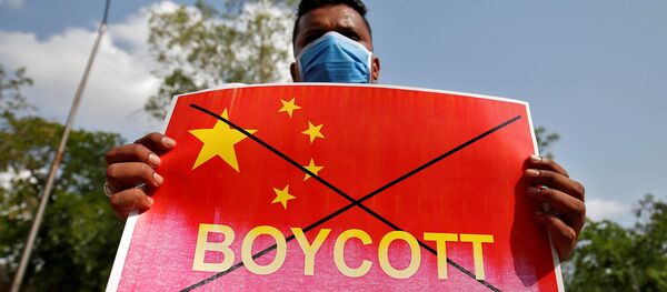 A member of National Students' Union of India (NSUI) holds a placard during a protest against China, in Ahmedabad, India, June 18, 2020. - Sputnik International