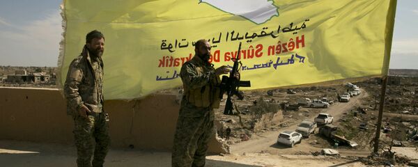 U.S.-backed Syrian Democratic Forces (SDF) fighters pose for a photo on a rooftop overlooking Baghouz, Syria, after the SDF declared the area free of Islamic State militants after months of fighting on Saturday, March 23, 2019 U.S.-backed Syrian Democratic Forces (SDF) fighters pose for a photo on a rooftop overlooking Baghouz, Syria, after the SDF declared the area free of Islamic State militants after months of fighting on Saturday, March 23, 2019 - Sputnik International