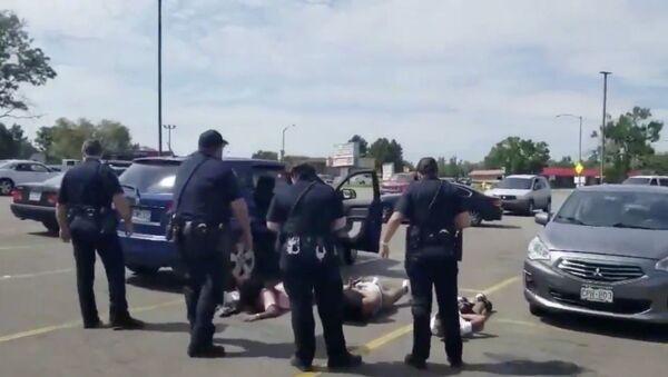 Cellphone footage captures members of Colorado's Aurora Police Department detaining and placing handcuffs on young children who were ordered to lay facedown on the ground as part of department protocol for stolen vehicle cases. The August 2, 2020, incident was later determined to be a mistake after officers determined that they'd zeroed in on the incorrect vehicle. - Sputnik International
