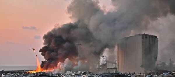 EDITORS NOTE: Graphic content / A helicopter puts out a fire at the scene of an explosion at the port of Lebanon's capital Beirut on August 4, 2020. (Photo by STR / AFP) - Sputnik International