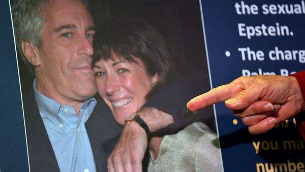(FILES) In this file photo taken on July 2, 2020 a photo of Ghislaine Maxwell and Jeffrey Epstein is seen as acting US Attorney for the Southern District of New York, Audrey Strauss, announces charges against Maxwell during a press conference in New York City - Sputnik International