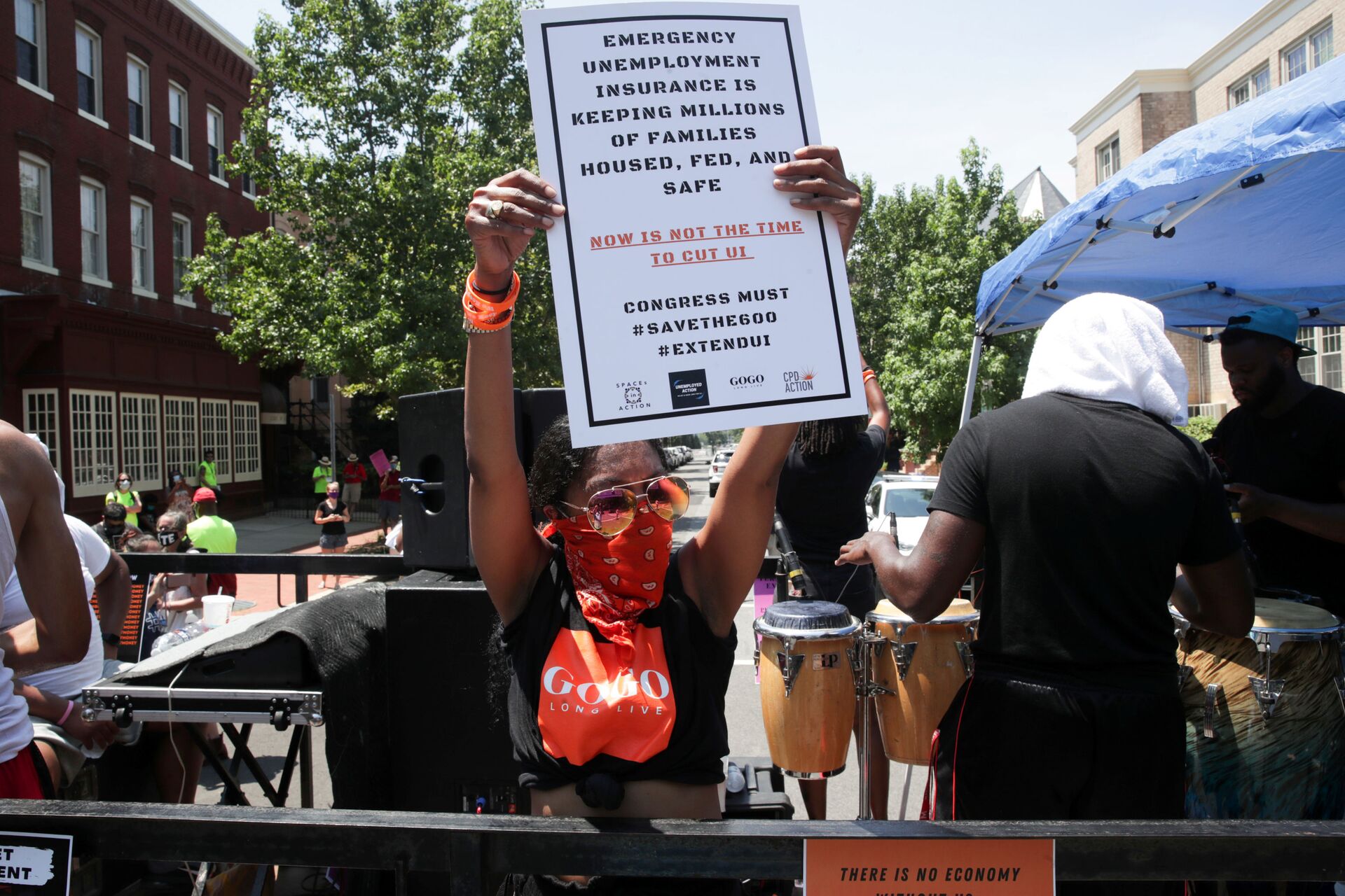 A person holds a placard as protesters temporarily block the street to U.S. Senate Majority Leader Mitch McConnell's (R-KY) house with a live band on a flatbed truck, demanding the extension of coronavirus disease (COVID-19)-related unemployment aid, on Capitol Hill in Washington, U.S. July 22, 2020 - Sputnik International, 1920, 07.09.2021