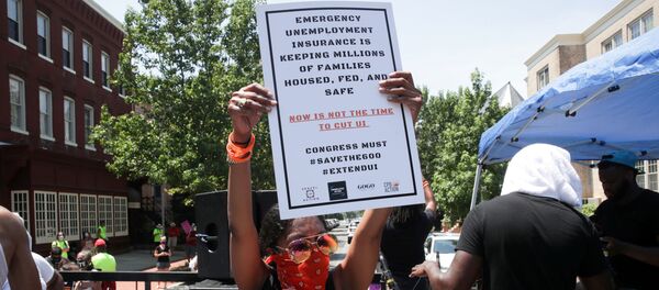 A person holds a placard as protesters temporarily block the street to U.S. Senate Majority Leader Mitch McConnell's (R-KY) house with a live band on a flatbed truck, demanding the extension of coronavirus disease (COVID-19)-related unemployment aid, on Capitol Hill in Washington, U.S. July 22, 2020 A person holds a placard as protesters temporarily block the street to U.S. Senate Majority Leader Mitch McConnell's (R-KY) house with a live band on a flatbed truck, demanding the extension of coronavirus disease (COVID-19)-related unemployment aid, on Capitol Hill in Washington, U.S. July 22, 2020 - Sputnik International