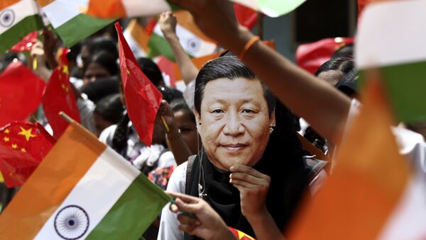 FILE- In this 10 October 2019 file photo, an Indian schoolgirl wears a face mask featuring Chinese President Xi Jinping to welcome him on the eve of his visit in Chennai, India - Sputnik International