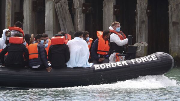 A British Border Force vessel carries a group of men thought to be migrants into Dover harbour, Southern England, Tuesday, 4 August 2020 - Sputnik International