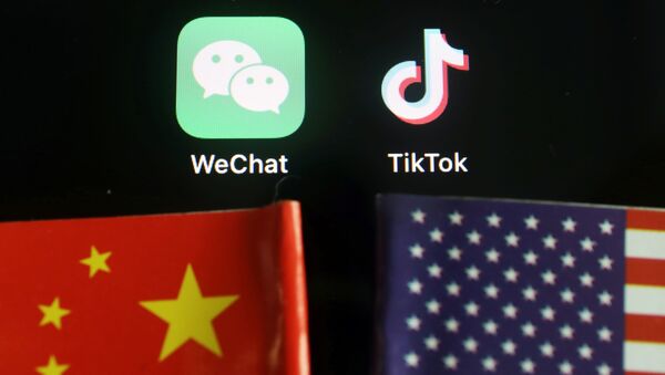 The messenger app WeChat and short-video app TikTok are seen near China and U.S. flags in this illustration picture taken August 7, 2020 - Sputnik International
