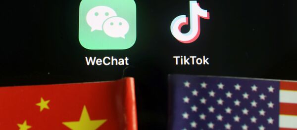 The messenger app WeChat and short-video app TikTok are seen near China and U.S. flags in this illustration picture taken August 7, 2020 The messenger app WeChat and short-video app TikTok are seen near China and U.S. flags in this illustration picture taken August 7, 2020 - Sputnik International