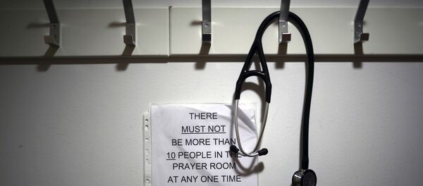 In this Thursday, May 14, 2020 photo, a stethoscope hangs on a coat hook at the entrance to the Muslim prayer room, at the Royal Blackburn Teaching Hospital, in Blackburn, England, amid the coronavirus pandemic In this Thursday, May 14, 2020 photo, a stethoscope hangs on a coat hook at the entrance to the Muslim prayer room, at the Royal Blackburn Teaching Hospital, in Blackburn, England, amid the coronavirus pandemic - Sputnik International