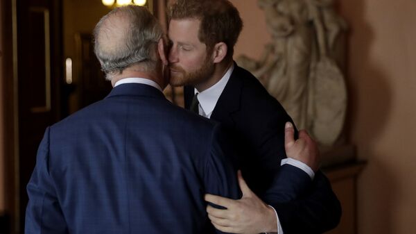 Britain's Prince Harry kisses and greets his father Prince Charles upon their separate arrival to attend a coral reef health and resilience meeting with speeches and a reception with delegates at Fishmongers Hall in London, 14 February 2018 - Sputnik International