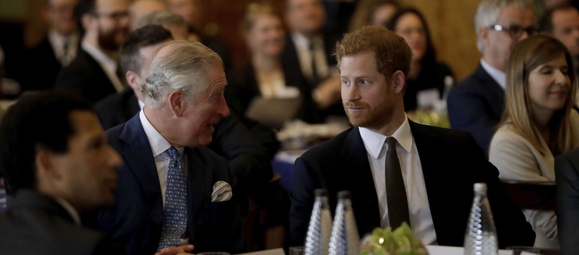 Britain's Prince Harry sits with his father Prince Charles, accompanying him to attend a coral reef health and resilience meeting with speeches and a reception with delegates at Fishmongers Hall in London, Wednesday, Feb. 14, 2018 - Sputnik International, 1920, 10.05.2021