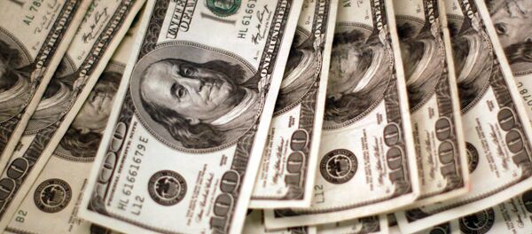 Four thousand US dollars are counted out by a banker counting currency at a bank in Westminster, Colorado, 3 November 2009 Four thousand US dollars are counted out by a banker counting currency at a bank in Westminster, Colorado, 3 November 2009 - Sputnik International