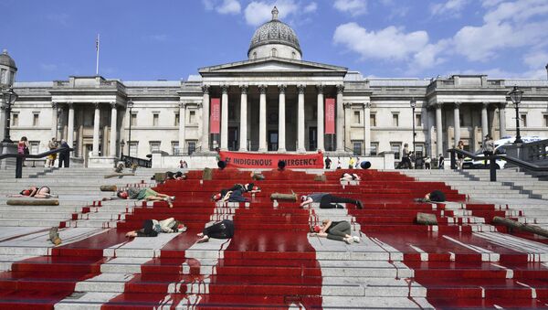 Red dye covers the steps outside the National Gallery of art as Extinction Rebellion protesters symbolically play dead, in a solidarity action for indigenous communities in Brazil - Sputnik International