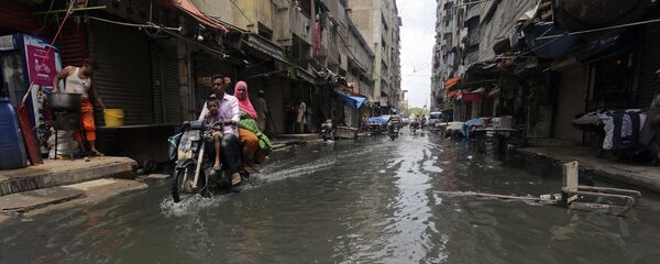 A motorcyclist drives through a street flooded by heavy rainfall in Karachi, Pakistan, Sunday, Aug. 9, 2020 A motorcyclist drives through a street flooded by heavy rainfall in Karachi, Pakistan, Sunday, Aug. 9, 2020 - Sputnik International