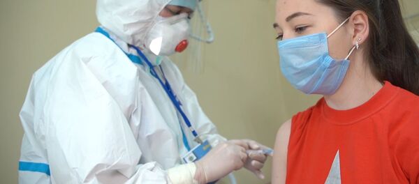 In this handout photo released by the Russian Defence Ministry, a medical worker wearing protective gear conducts daily rounds with a participant in a coronavirus vaccine trial during tests at the Burdenko Main Military Clinical Hospital in Moscow, Russia In this handout photo released by the Russian Defence Ministry, a medical worker wearing protective gear conducts daily rounds with a participant in a coronavirus vaccine trial during tests at the Burdenko Main Military Clinical Hospital in Moscow, Russia - Sputnik International