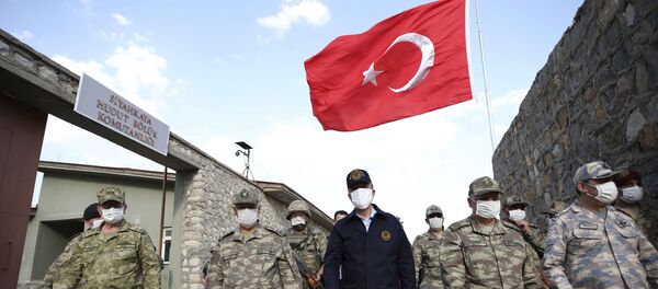 In this photo taken Friday, June 19, 2020, Turkish Defense Minister Hulusi Akar, centre, wearing a face mask to protect against coronavirus, visits Turkish troops at the border with Iraq, in Hakkari province, Turkey. Turkish army's operation continues after it said Wednesday it has airlifted troops for a cross-border ground operation against Kurdish militants in northern Iraq In this photo taken Friday, June 19, 2020, Turkish Defense Minister Hulusi Akar, centre, wearing a face mask to protect against coronavirus, visits Turkish troops at the border with Iraq, in Hakkari province, Turkey. Turkish army's operation continues after it said Wednesday it has airlifted troops for a cross-border ground operation against Kurdish militants in northern Iraq - Sputnik International