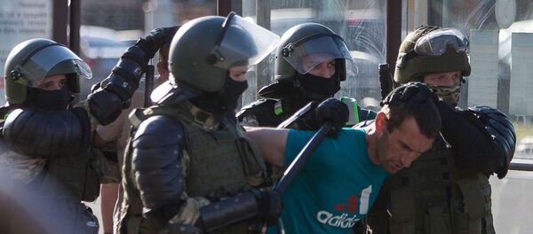Belarusian law enforcement officers detain a man near the site where a protester died on August 10 during a rally following the presidential election in Minsk, Belarus August 11, 2020. The opposition rejected official election results handing President Alexander Lukashenko a landslide re-election victory Belarusian law enforcement officers detain a man near the site where a protester died on August 10 during a rally following the presidential election in Minsk, Belarus August 11, 2020. The opposition rejected official election results handing President Alexander Lukashenko a landslide re-election victory - Sputnik International
