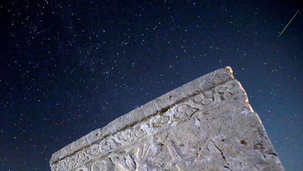 A meteor streaks past stars in the night sky above medieval tombstones during the Perseid meteor shower in Radimlja near Stolac, Bosnia and Herzegovina, August 12, 2020 - Sputnik International