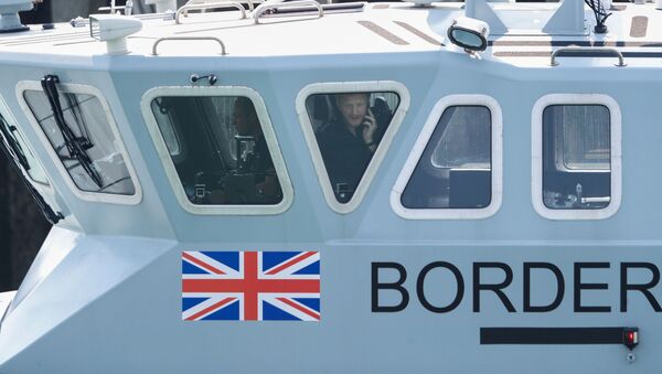 An officer looks out of a window at Dover harbour from a Border Force boat, in Dover, Britain August 11, 2020.  - Sputnik International