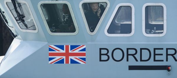 An officer looks out of a window at Dover harbour from a Border Force boat, in Dover, Britain August 11, 2020.  - Sputnik International