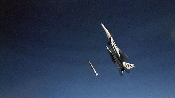 An air-to-air left side view of an F-15 Eagle aircraft releasing an anti-satellite (ASAT) missile during a test on Sep. 13, 1985, at the Pacific Missile Test Range, CA - Sputnik International