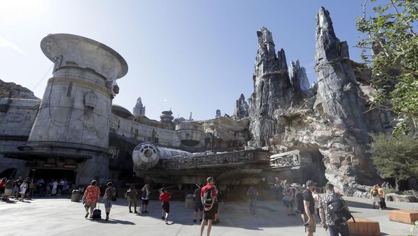 Park visitors walk near the entrance to the Millennium Falcon Smugglers Run ride during a preview of the Star Wars themed land, Galaxy's Edge in Hollywood Studios at Disney World, Tuesday, Aug. 27, 2019, in Lake Buena Vista, Fla. - Sputnik International