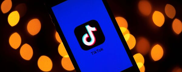 (FILES) This file photo taken on November 21, 2019 shows the logo of the social media video sharing app Tiktok displayed on a tablet screen in Paris - Sputnik International