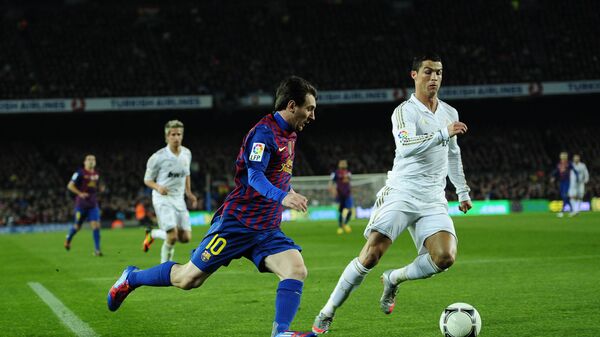 FC Barcelona's Lionel Messi, from Argentina, left, duels for the ball against Real Madrid's Cristiano Ronaldo, from Portugal, during their quarterfinal, second leg, Copa del Rey soccer match at the Camp Nou stadium, in Barcelona, Spain, Wednesday, 25 January 2012 - Sputnik International