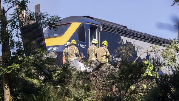 Emergency services attend the scene of a derailed train in Stonehaven, Scotland, Wednesday Aug. 12, 2020 - Sputnik International