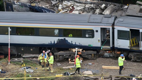 Emergency services inspect the site, following the derailment of the ScotRail train which cost the lives of three people, near Stonehaven, Aberdeenshire, Scotland, Britain August 13, 2020. - Sputnik International