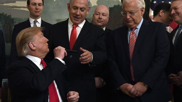 President Donald Trump, left, turns to give a pen to Israeli Prime Minister Benjamin Netanyahu, center, after signing a proclamation in the Diplomatic Reception Room at the White House in Washington, Monday, March 25, 2019. Trump signed an official proclamation formally recognizing Israel's sovereignty over the Golan Heights. Other attending are, from left, White House adviser Jared Kushner, U.S. special envoy Jason Greenblatt, U.S. Ambassador to Israel David Friedman, Israeli Ambassador to the U. S. Ron Dermer, and Secretary of State Mike Pompeo. - Sputnik International