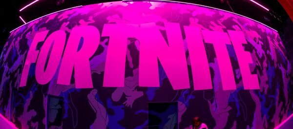 An attendee stops to text next to Epic Games Fortnite sign at E3, the annual video games expo revealing the latest in gaming software and hardware in Los Angeles, California, U.S., June 12, 2019. - Sputnik International