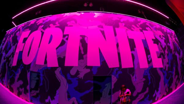An attendee stops to text next to Epic Games Fortnite sign at E3, the annual video games expo revealing the latest in gaming software and hardware in Los Angeles, California, U.S., June 12, 2019. - Sputnik International