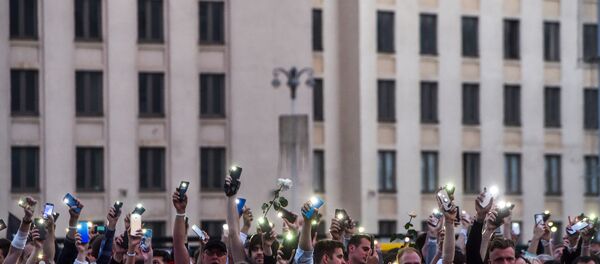 Demonstrators raise their mobile phones near the Government House in Independence Square during a protest rally against police violence during at rallies of opposition supporters, who accuse strongman Alexander Lukashenko of falsifying the polls in the presidential election, in central Minsk on August 14, 2020. - Crowds of workers walked off the job on August 14, 2020, at several factories in Belarus's capital Minsk in support of the opposition calling for leader Alexander Lukashenko to step down. Hundreds of workers marched from the Minsk Automobile Plant (MAZ) and the Minsk Tractor Works (MTZ) after the opposition called for strikes against Lukashenko's disputed claim to have won re-election. Demonstrators raise their mobile phones near the Government House in Independence Square during a protest rally against police violence during at rallies of opposition supporters, who accuse strongman Alexander Lukashenko of falsifying the polls in the presidential election, in central Minsk on August 14, 2020. - Crowds of workers walked off the job on August 14, 2020, at several factories in Belarus's capital Minsk in support of the opposition calling for leader Alexander Lukashenko to step down. Hundreds of workers marched from the Minsk Automobile Plant (MAZ) and the Minsk Tractor Works (MTZ) after the opposition called for strikes against Lukashenko's disputed claim to have won re-election. - Sputnik International