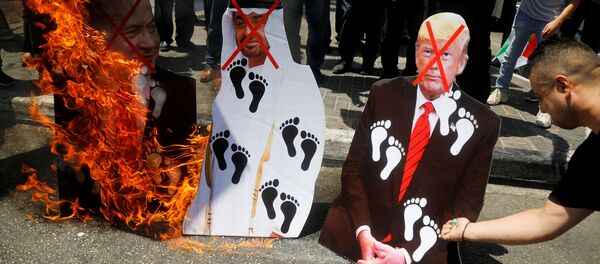 Palestinians burn cutouts depicting U.S. President Donald Trump and Abu Dhabi Crown Prince Mohammed bin Zayed al-Nahyan and Israeli Prime Minister Benjamin Netanyahu during a protest against the United Arab Emirates' deal with Israel to normalise relations, in Nablus in the Israeli-occupied West Bank August 14, 2020. - Sputnik International