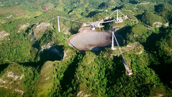 The world's largest radio telescope is seen from the air in this Wednesday, March 26, 2003 photo at the Arecibo Observatory, Puerto Rico - Sputnik International