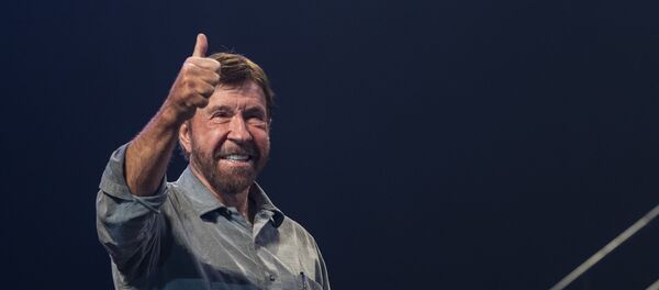 US actor and martial artist Chuck Norris, this year's special guest signals to the audience onstage during the opening gala of the 15th Shoe Box fundraising event in Papp Laszlo Sports Arena in Budapest, Hungary, Saturday, Nov. 24, 2018. The annual Christmas charity campaign was launched by the Hungarian Baptist Aid (HBAid) in 2004 to collect and distribute gifts donated by the public for underprivileged children during Advent. The organisation receives the labelled and boxed presents at nearly 300 designated collection points in the country.  - Sputnik International