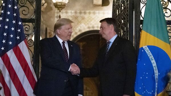 In this March 7, 2020, file photo President Donald Trump shakes hands before a dinner with Brazilian President Jair Bolsonaro at Mar-a-Lago in Palm Beach, Fla. Bolsonaro’s communications director, Fábio Wajngarten, tested positive just days after traveling with Bolsonaro to a meeting with Trump and senior aides in Florida. - Sputnik International